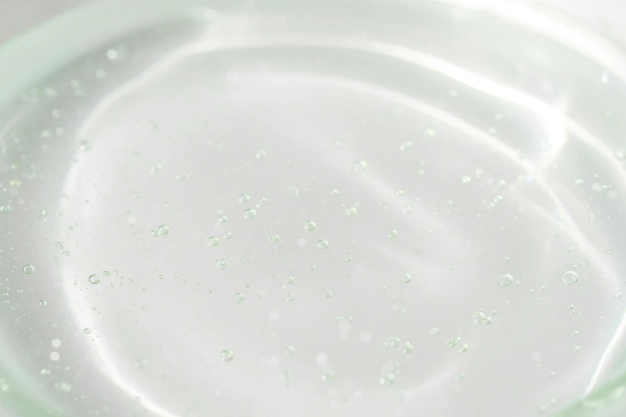 Bright water surface with fine bubbles and soft reflections.
