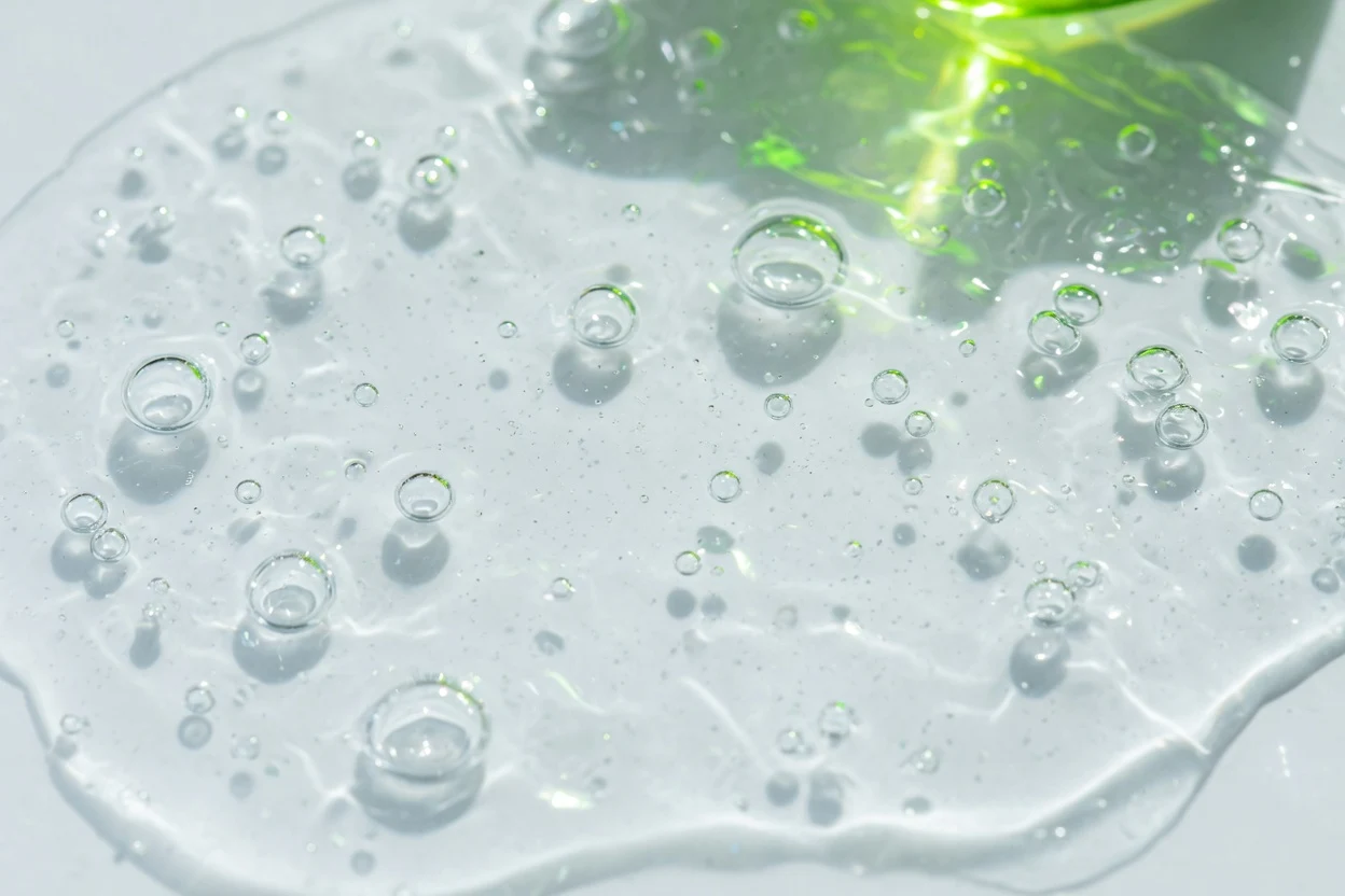 Bright water surface with many clear bubbles and green reflections.